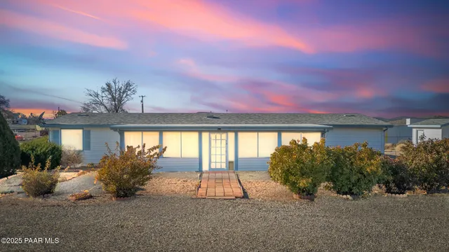 a living room with furniture a chandelier and a window