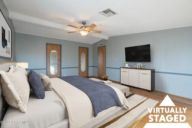 a bedroom with a bed and a painting on the wall