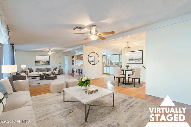a living room with furniture potted plant and a chandelier