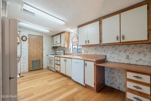a kitchen with granite countertop a refrigerator and a sink