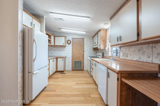 a view of kitchen with stainless steel appliances granite countertop