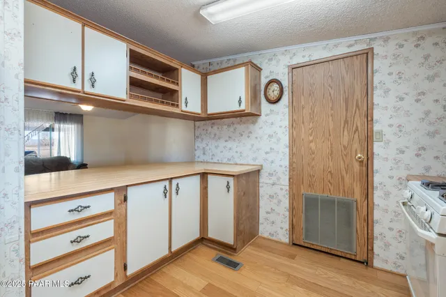 a living room with furniture a chandelier and a flat screen tv