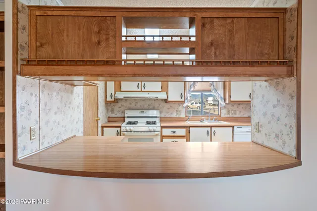 a bedroom with a bed a couch and potted plant