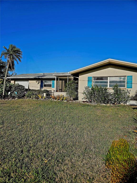 134 Gulfview Road Punta Gorda, FL 33950 - Photo 1 of 1 a front view of a house with garden