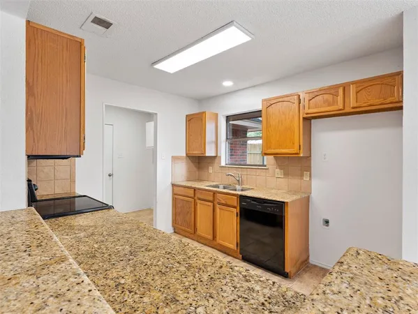 a spacious bathroom with a granite countertop sink and a mirror