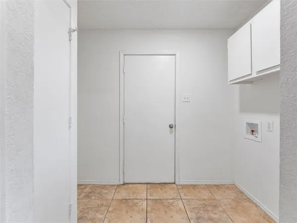a view of room with white door and cabinet