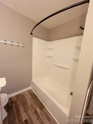 a bathroom with a bathtub and a toilet