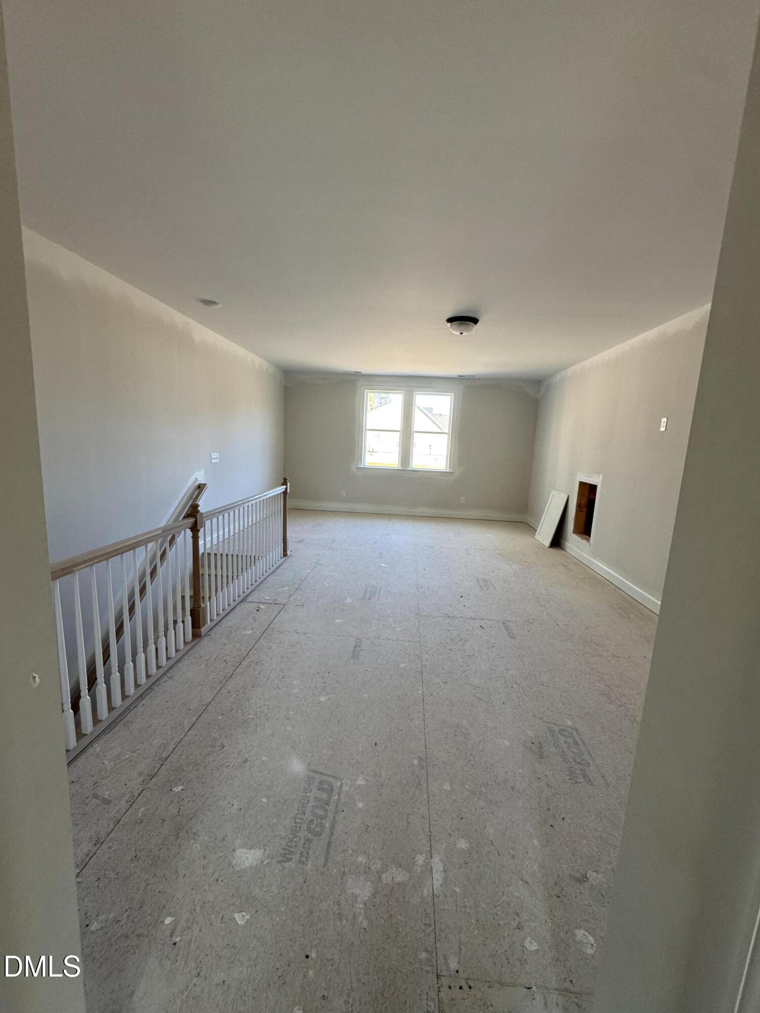 134 West Victoria Rdg Drive, Unit 22 Selma, NC 27576 - Photo 16 of 18 a view of empty room with stairs and windows