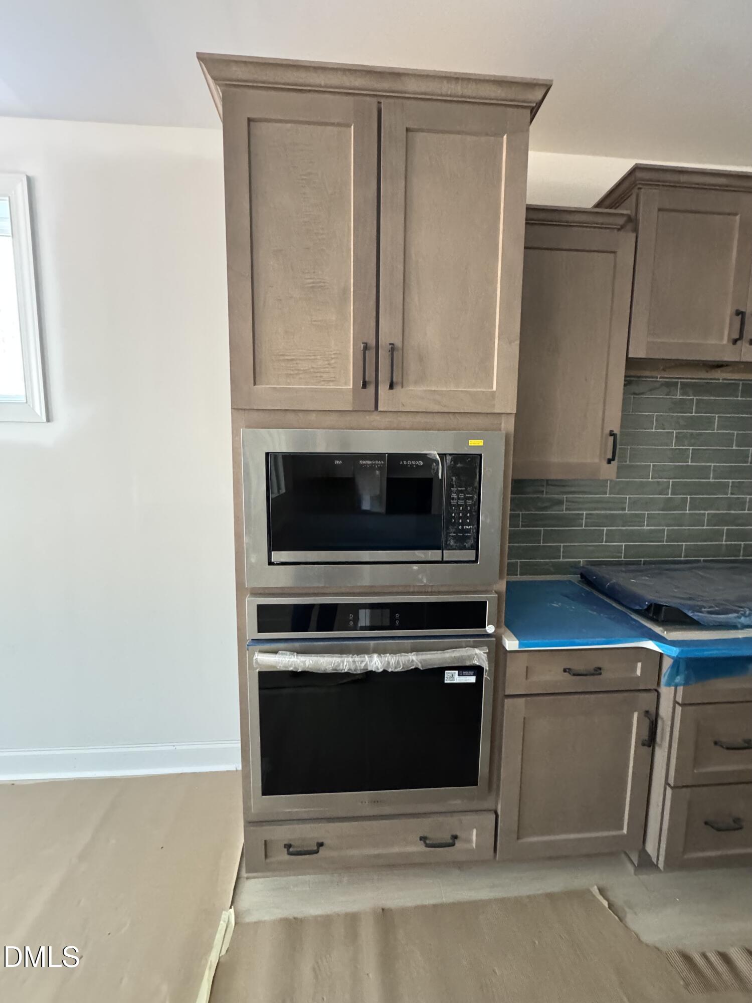 134 West Victoria Rdg Drive, Unit 22 Selma, NC 27576 - Photo 5 of 18 a kitchen with granite countertop white cabinets and stainless steel appliances