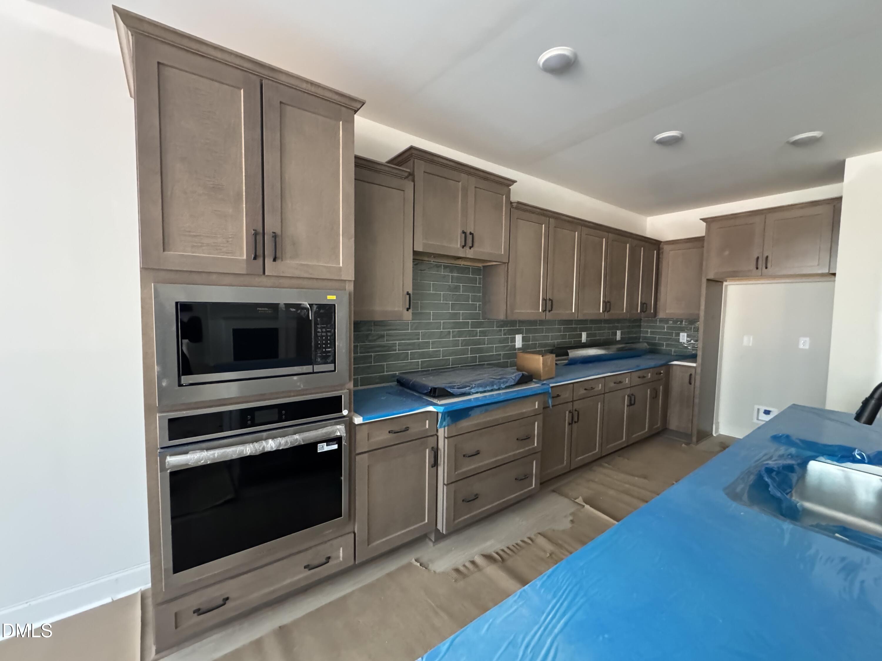 134 West Victoria Rdg Drive, Unit 22 Selma, NC 27576 - Photo 6 of 18 a kitchen with granite countertop wooden cabinets stainless steel appliances and a sink