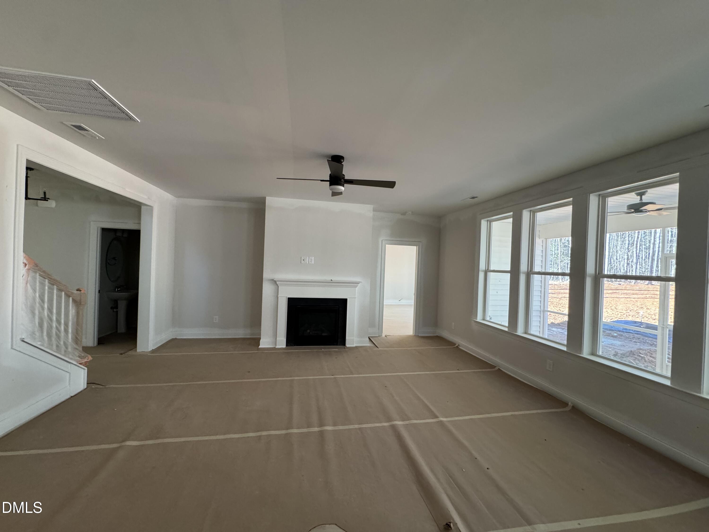 134 West Victoria Rdg Drive, Unit 22 Selma, NC 27576 - Photo 9 of 18 a view of an empty room with a fireplace and a window