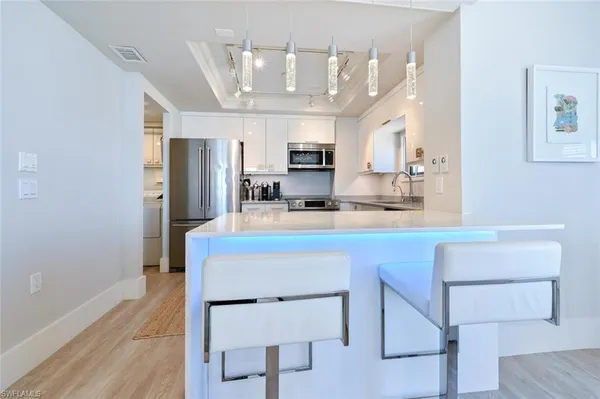 a kitchen with stainless steel appliances granite countertop a refrigerator and a stove top oven