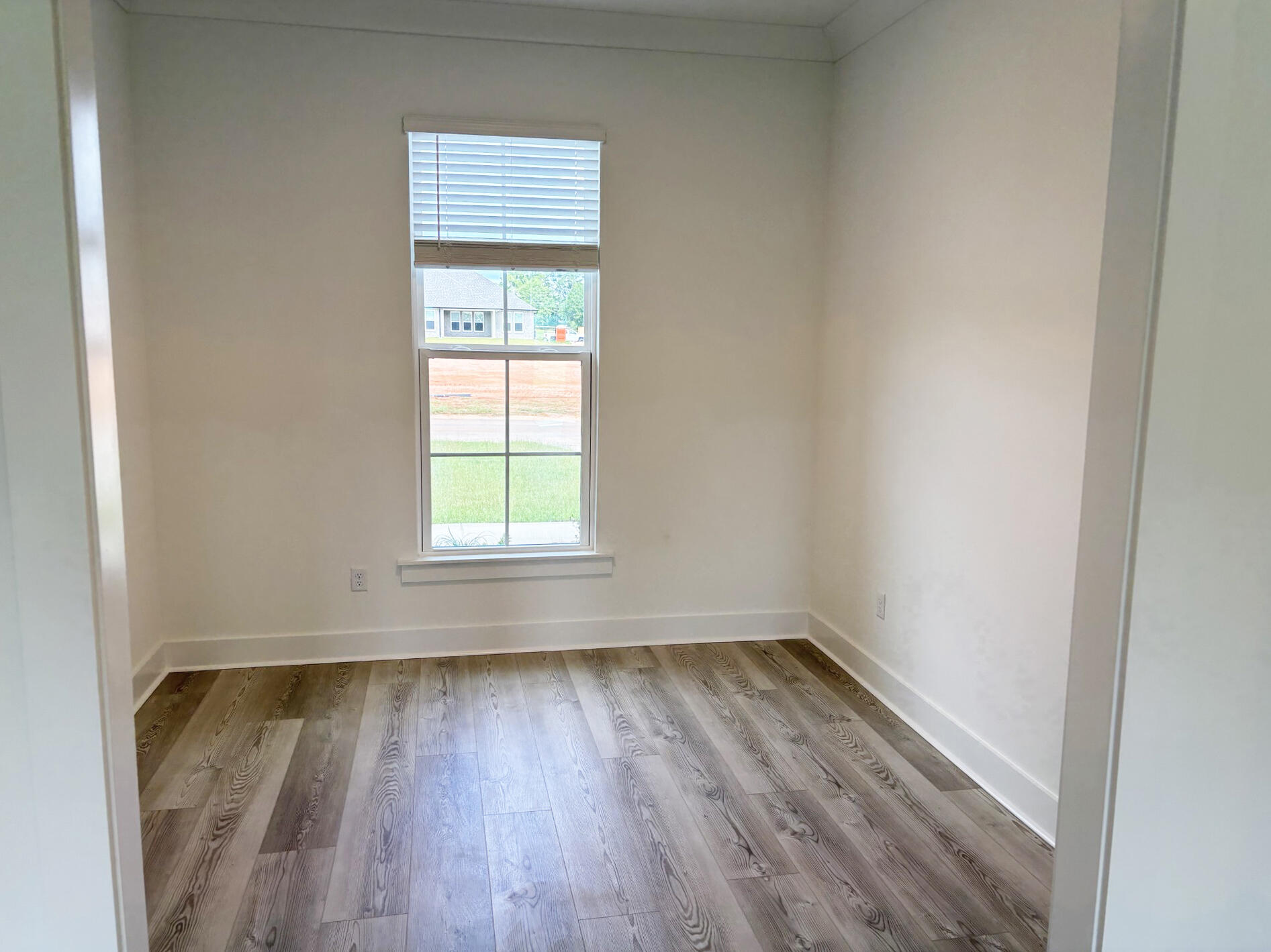 5800 Del Rio Crossing Crestview, FL 32539 - Photo 10 of 24 an empty room with wooden floor and windows