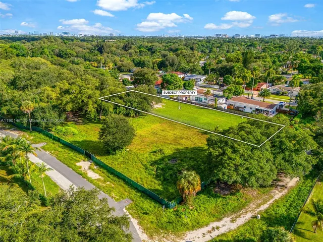 an aerial view of residential houses with yard