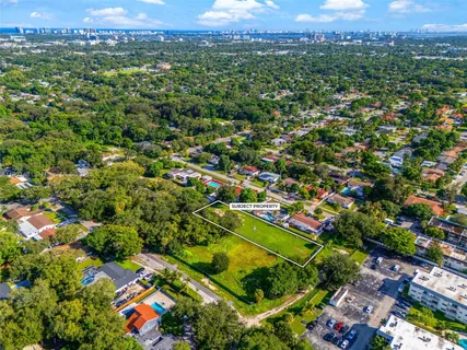an aerial view of a houses with a yard
