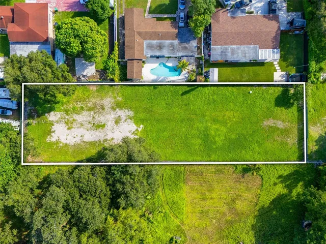 an aerial view of swimming pool with a yard