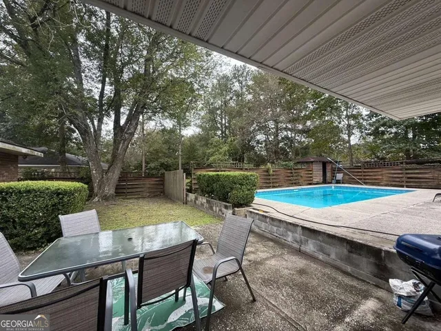 a view of yard with patio