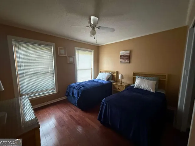 a bedroom with two beds and a window