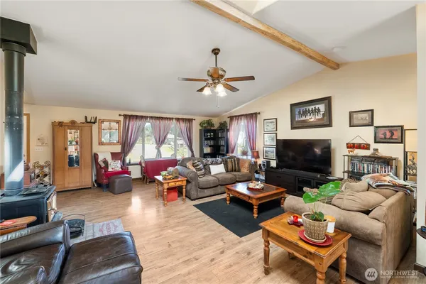 a living room with furniture fireplace and a window