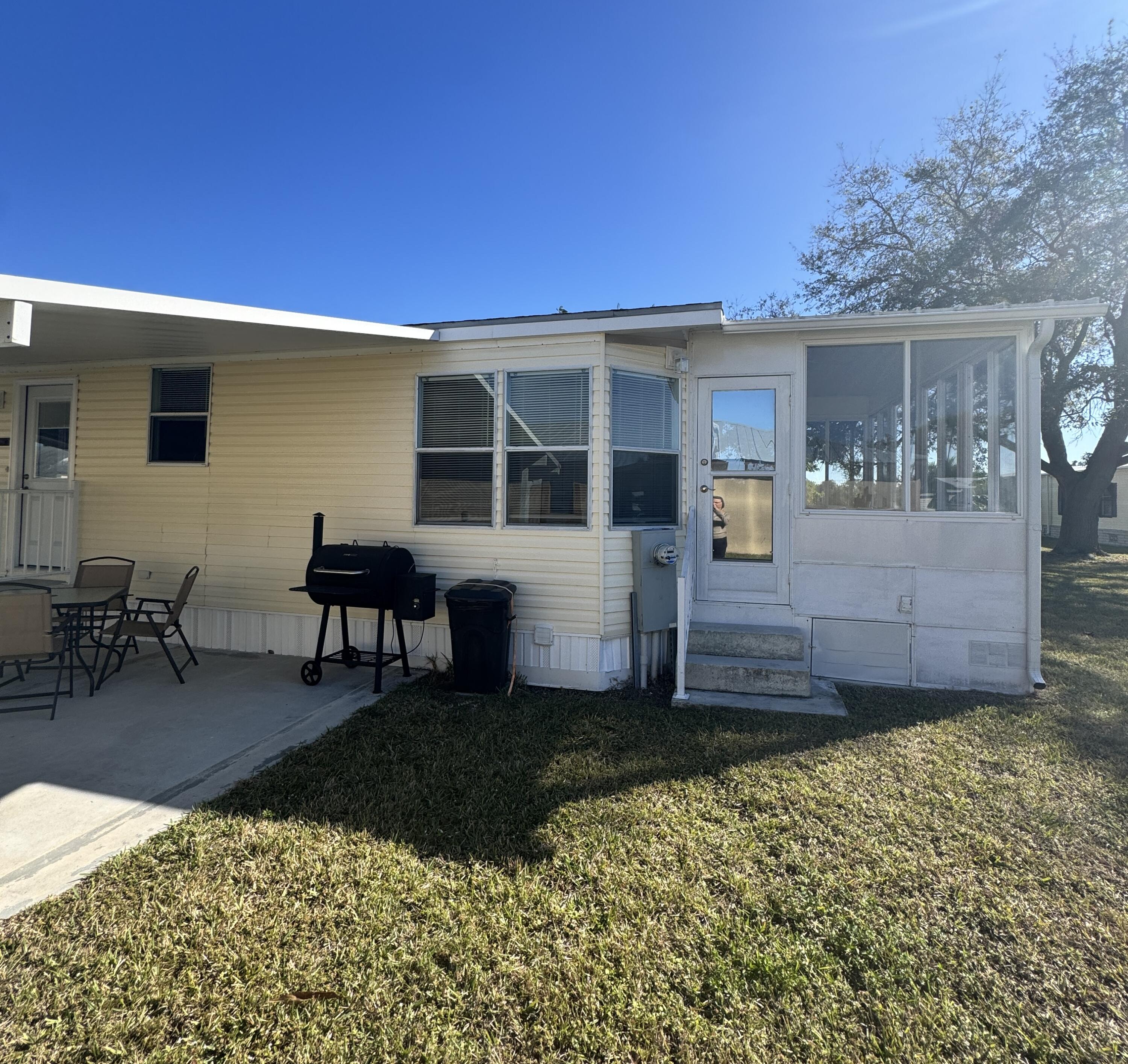 13965 Garza Court Fort Pierce, FL 34951 - Photo 11 of 44 a view of a house with backyard sitting area and garden