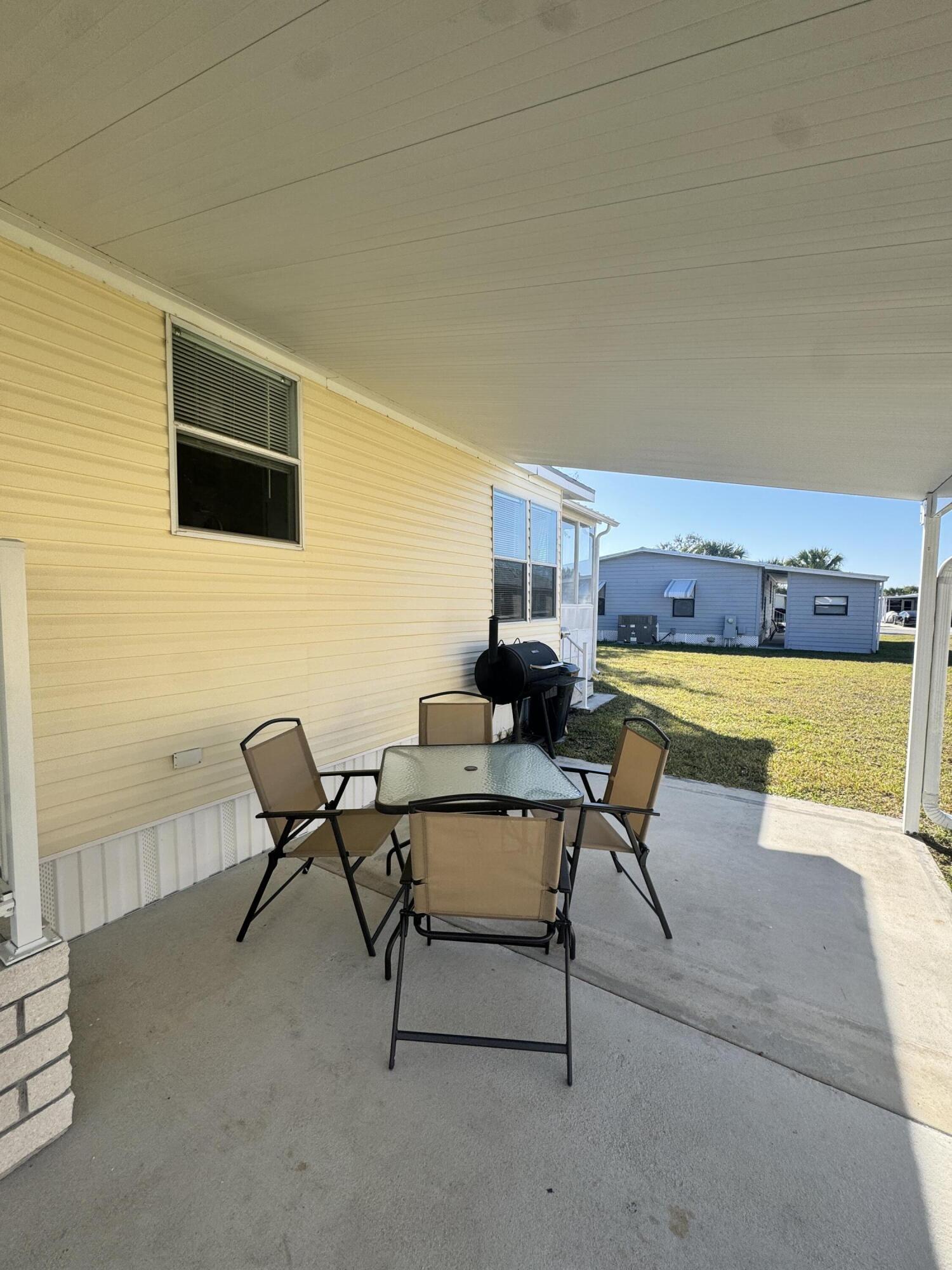 13965 Garza Court Fort Pierce, FL 34951 - Photo 13 of 44 a living room with a couch and a flat screen tv