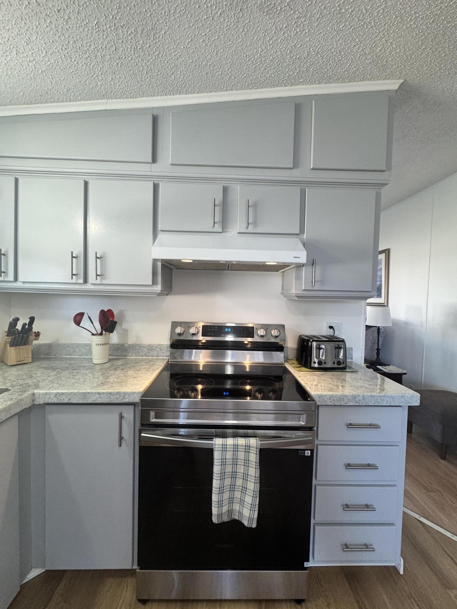 13965 Garza Court Fort Pierce, FL 34951 - Photo 15 of 44 a kitchen with stainless steel appliances a sink stove and cabinets