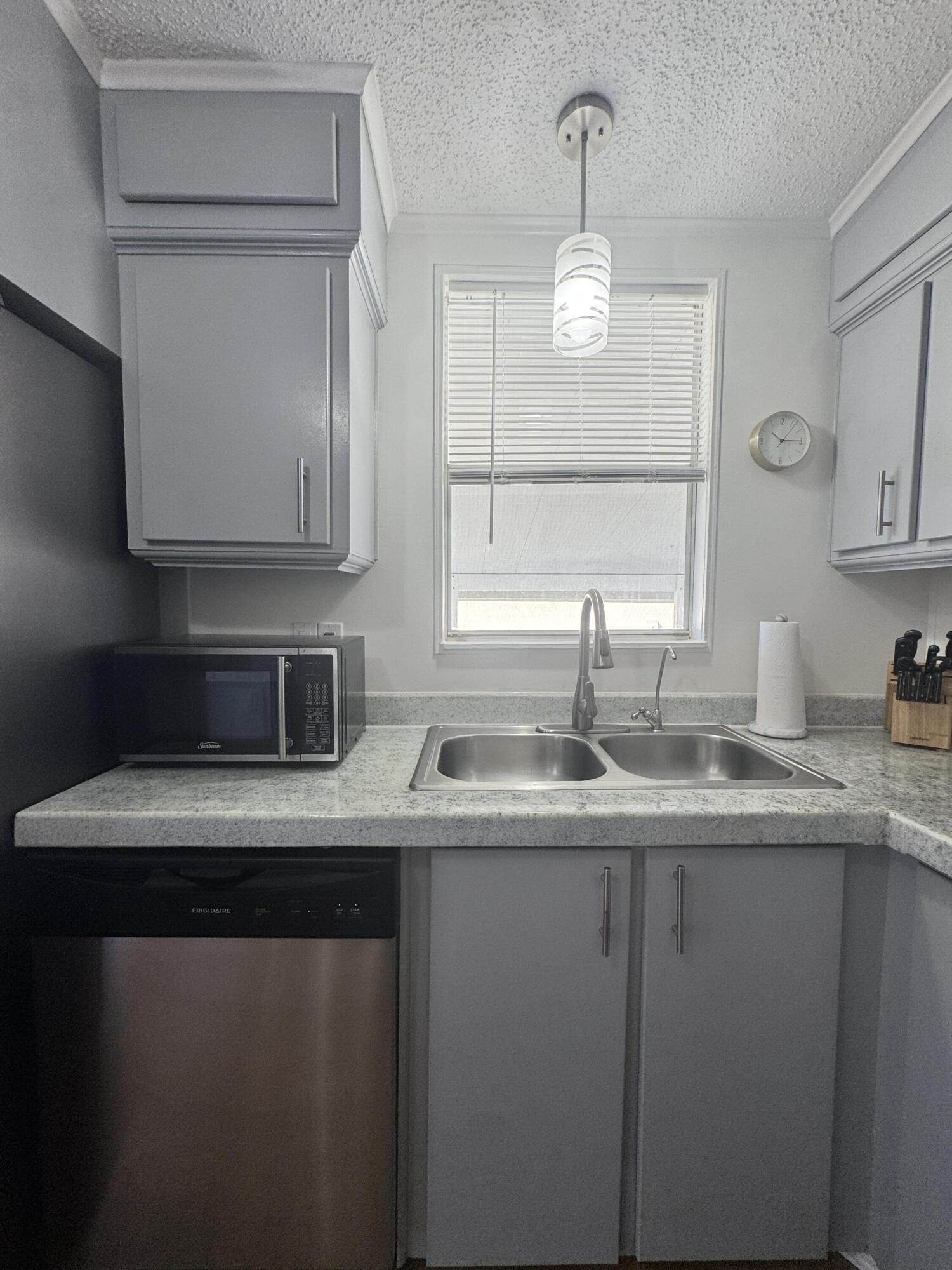13965 Garza Court Fort Pierce, FL 34951 - Photo 16 of 44 a kitchen with stainless steel appliances granite countertop a sink a stove and a microwave