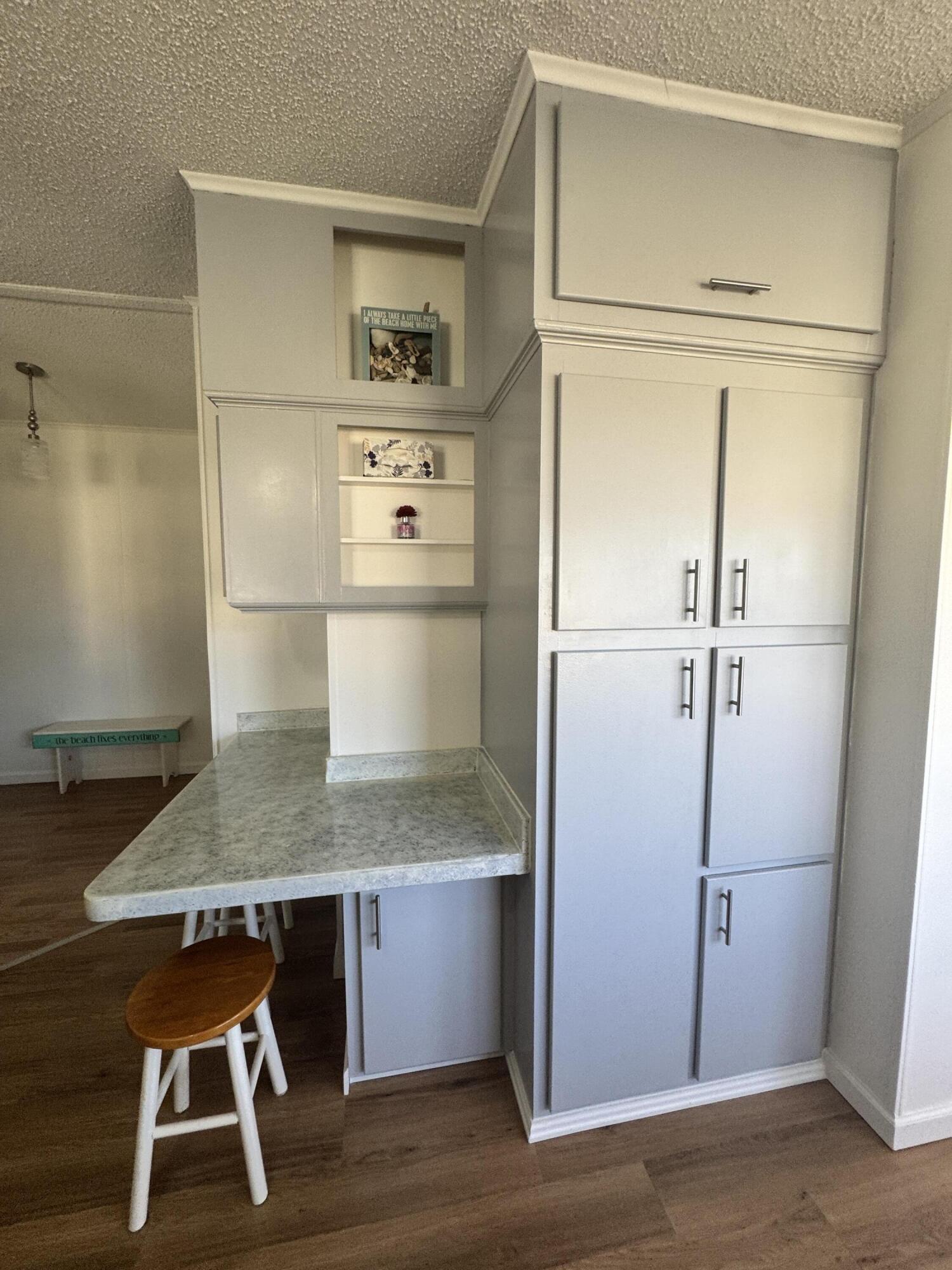 13965 Garza Court Fort Pierce, FL 34951 - Photo 19 of 44 a kitchen with a refrigerator and wooden cabinets