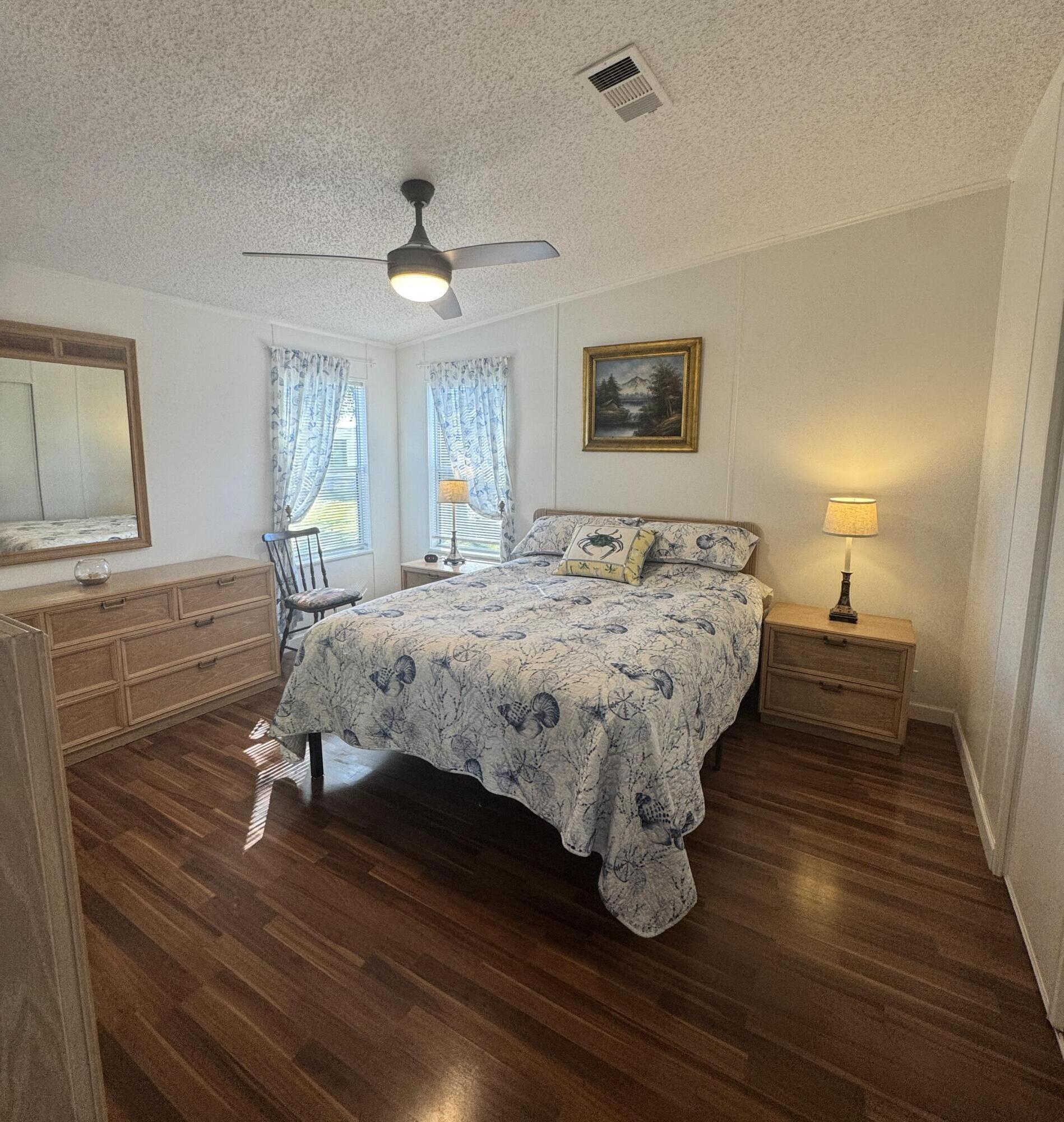 13965 Garza Court Fort Pierce, FL 34951 - Photo 22 of 44 a bedroom with a bed and wooden floor