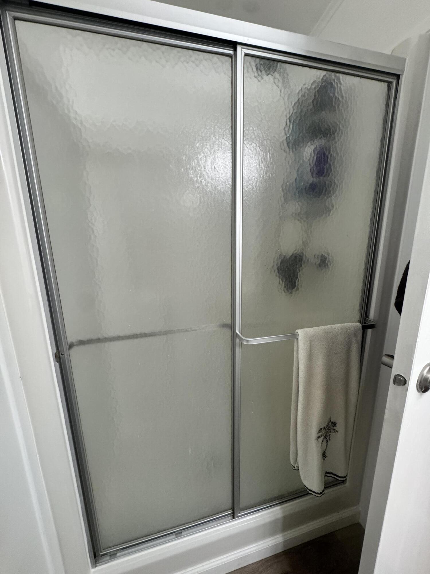 13965 Garza Court Fort Pierce, FL 34951 - Photo 25 of 44 a bathroom with a glass shower door