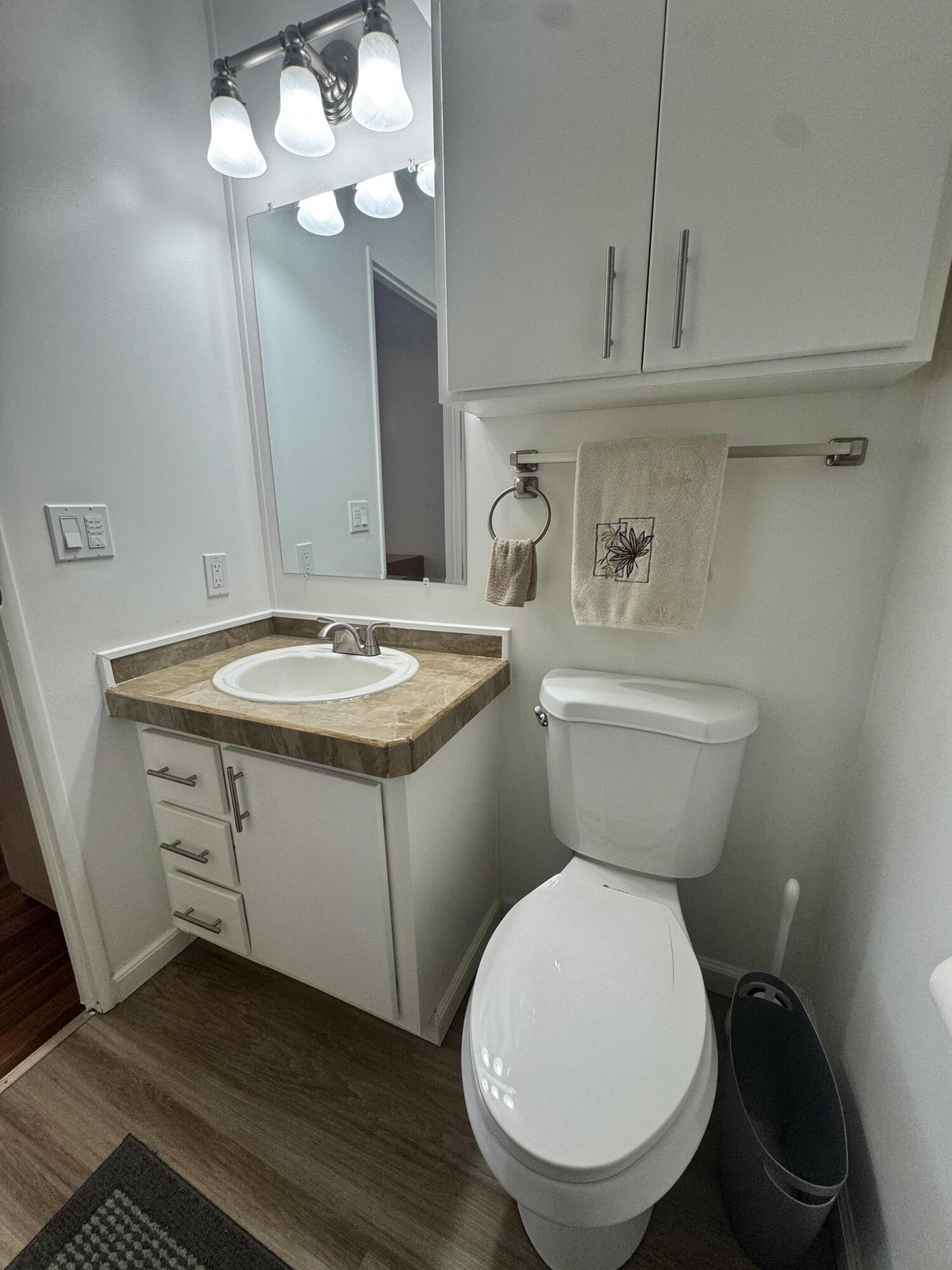 13965 Garza Court Fort Pierce, FL 34951 - Photo 26 of 44 a bathroom with a granite countertop toilet sink and mirror