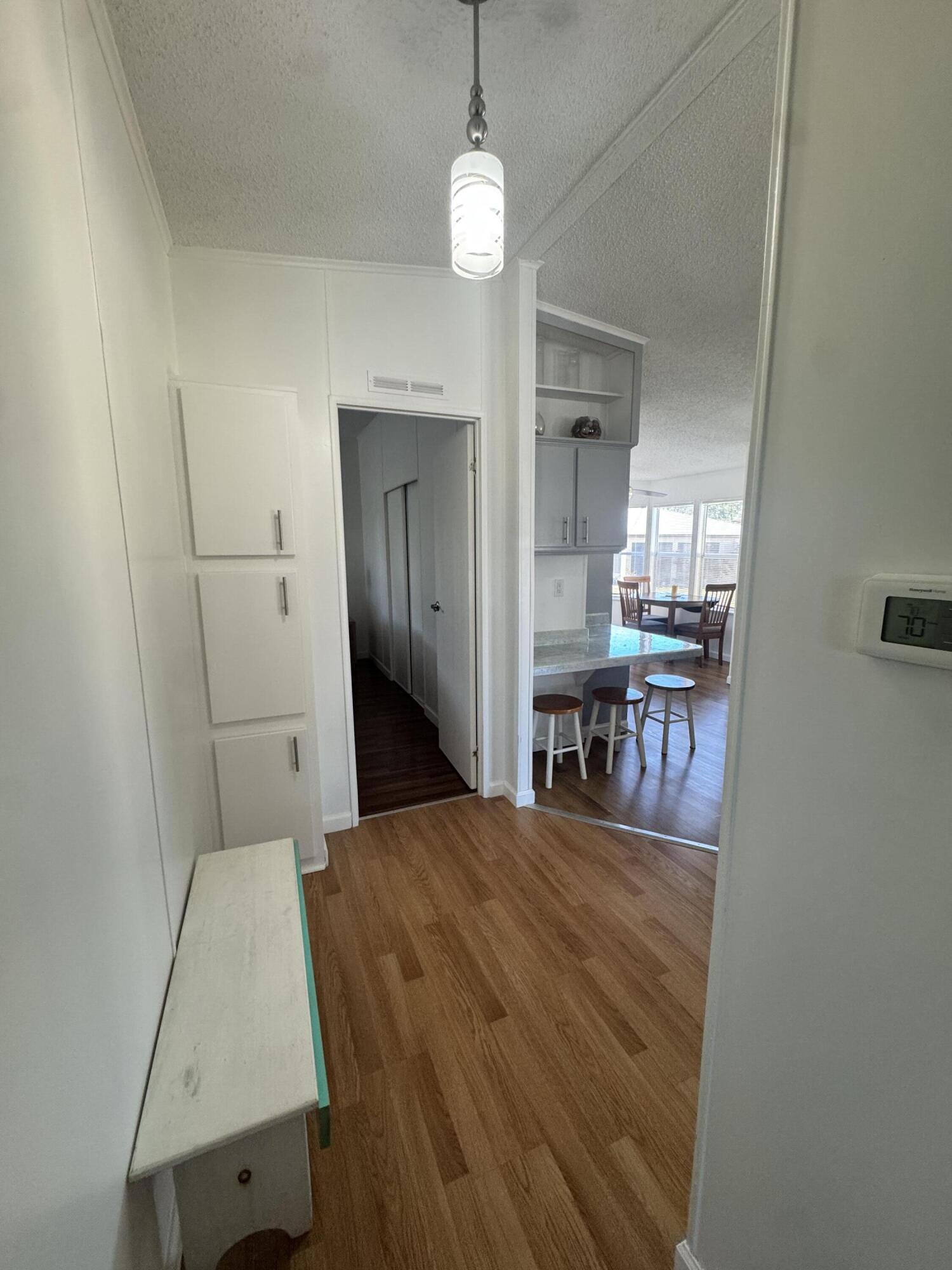 13965 Garza Court Fort Pierce, FL 34951 - Photo 27 of 44 a bedroom with a bed and a chandelier