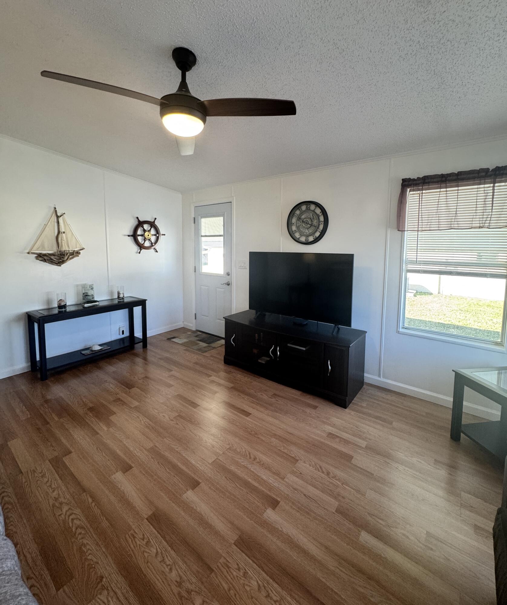 13965 Garza Court Fort Pierce, FL 34951 - Photo 32 of 44 a living room with furniture and a flat screen tv