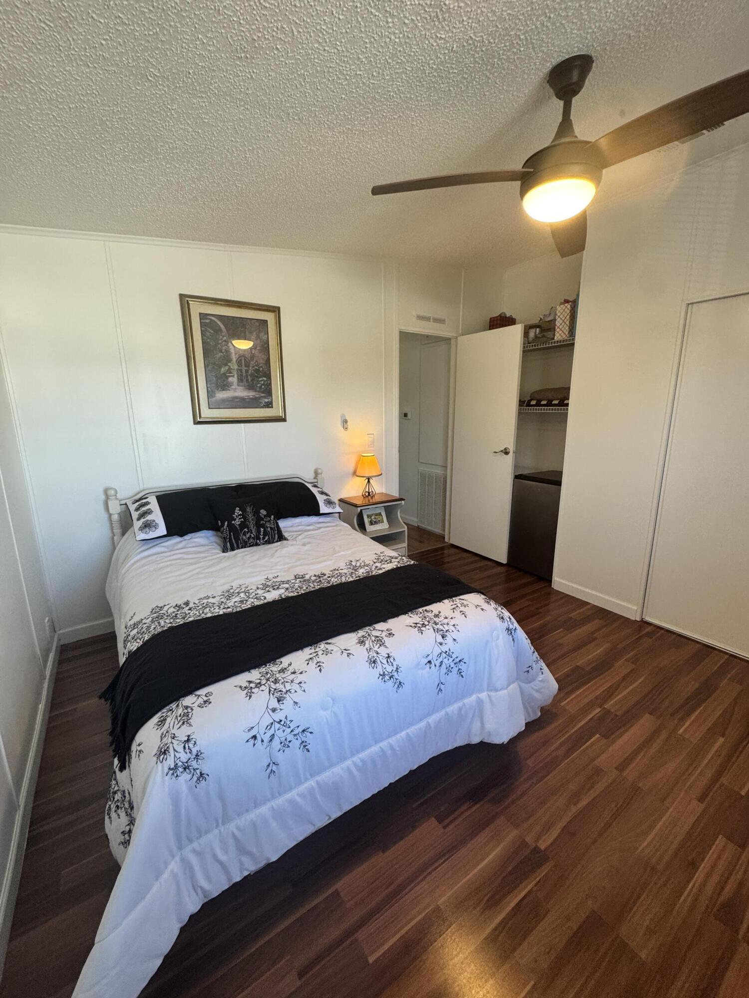 13965 Garza Court Fort Pierce, FL 34951 - Photo 35 of 44 a bedroom with a bed and a painting on the wall