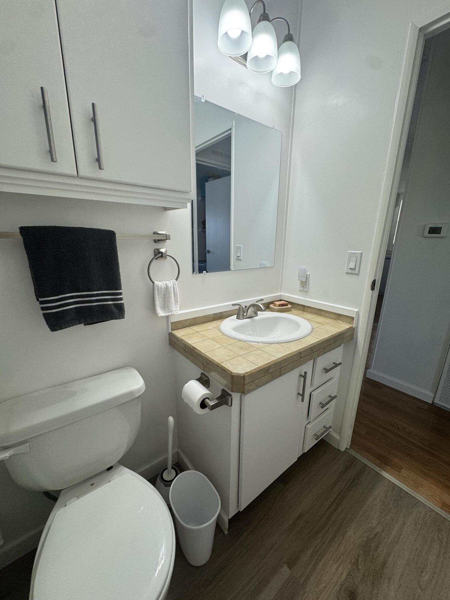 13965 Garza Court Fort Pierce, FL 34951 - Photo 38 of 44 a bathroom with a toilet sink and mirror