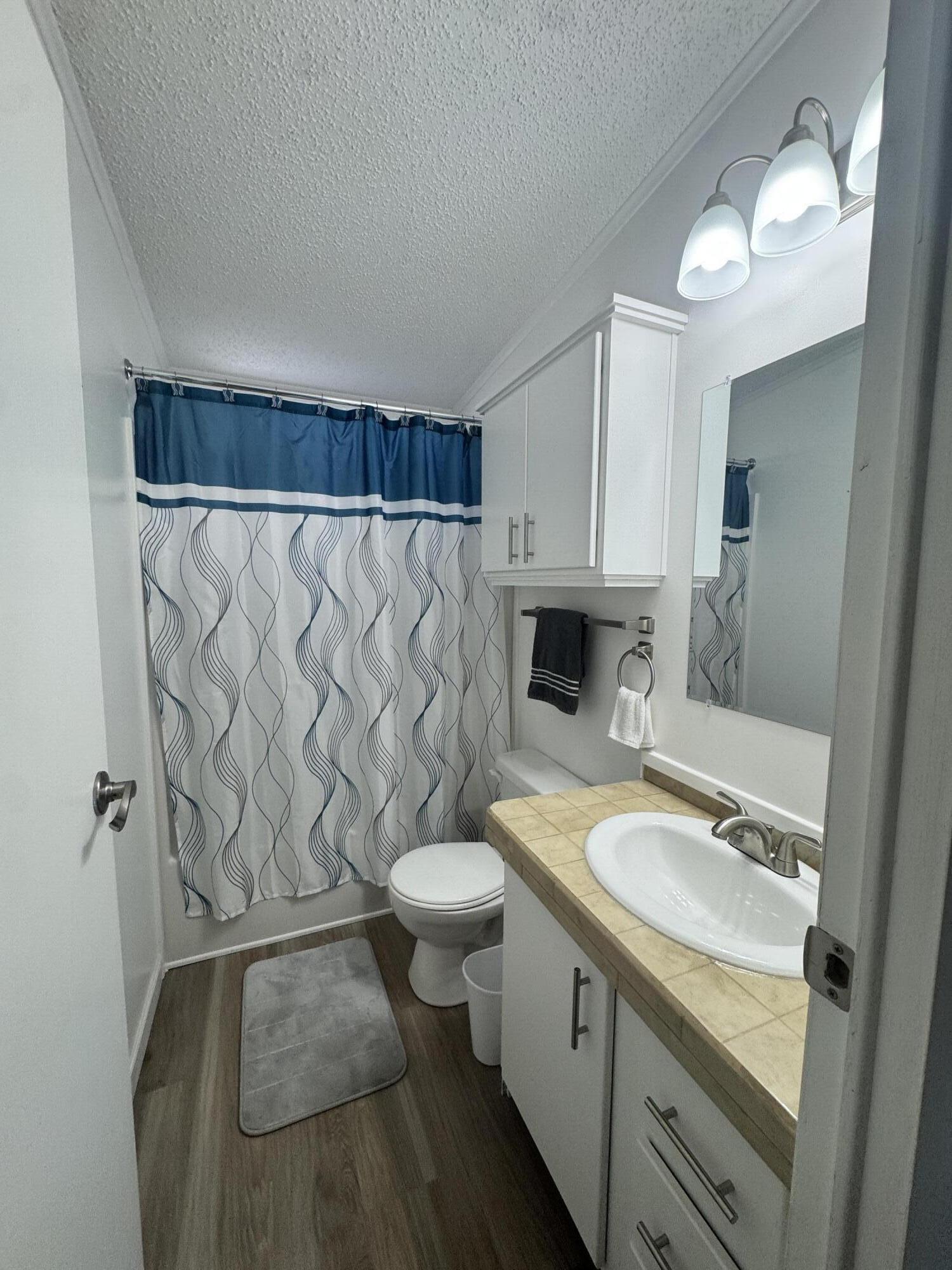 13965 Garza Court Fort Pierce, FL 34951 - Photo 39 of 44 a bathroom with a granite countertop bathtub sink vanity mirror and toilet