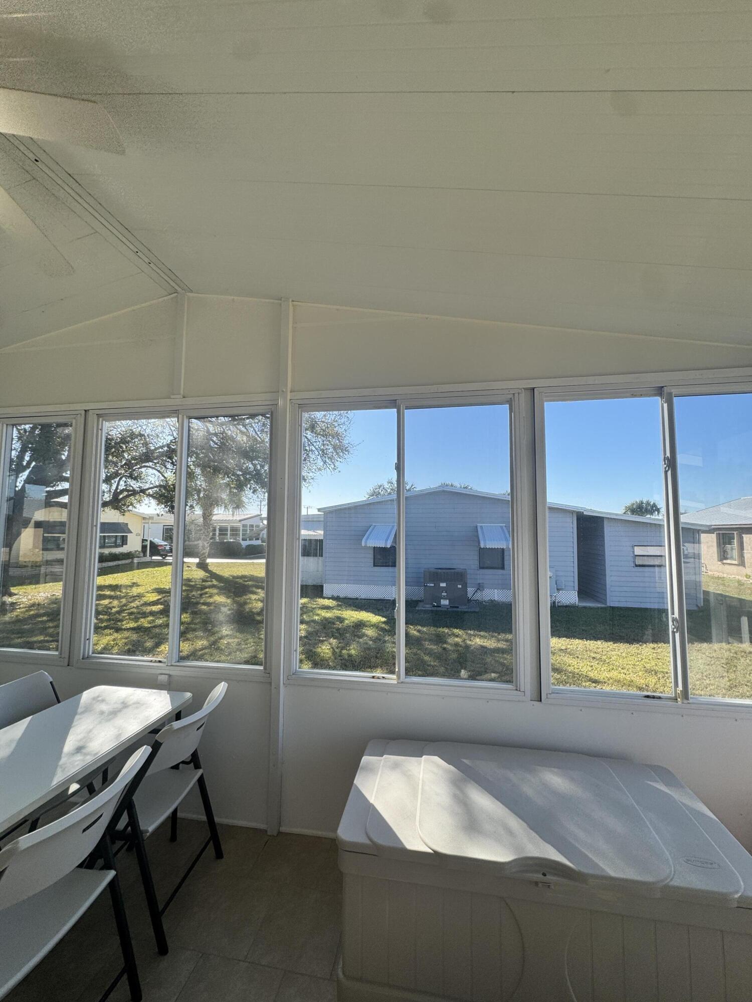 13965 Garza Court Fort Pierce, FL 34951 - Photo 41 of 44 a living room with a large window and a table