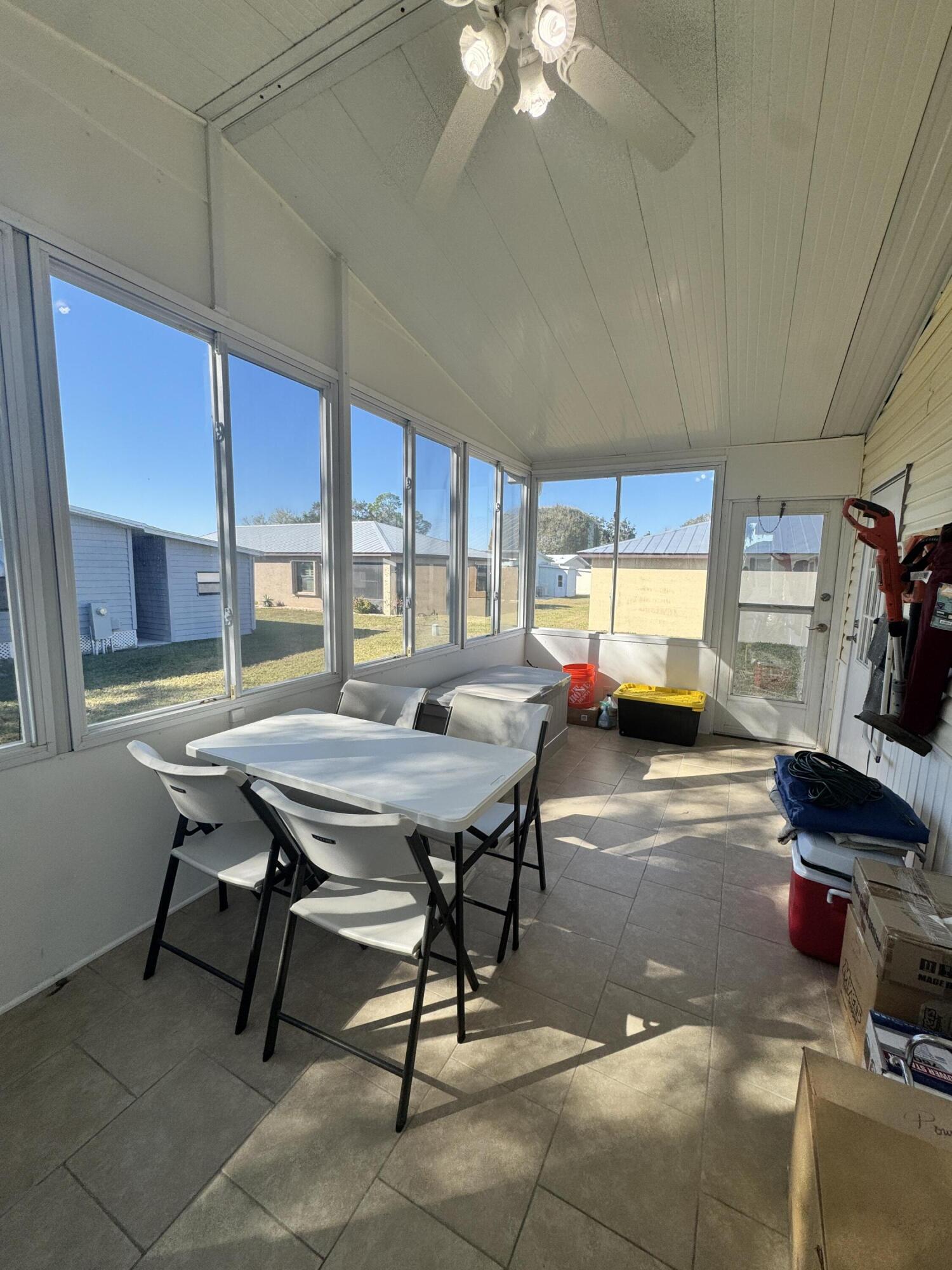 13965 Garza Court Fort Pierce, FL 34951 - Photo 42 of 44 a living room with furniture a table and a large window