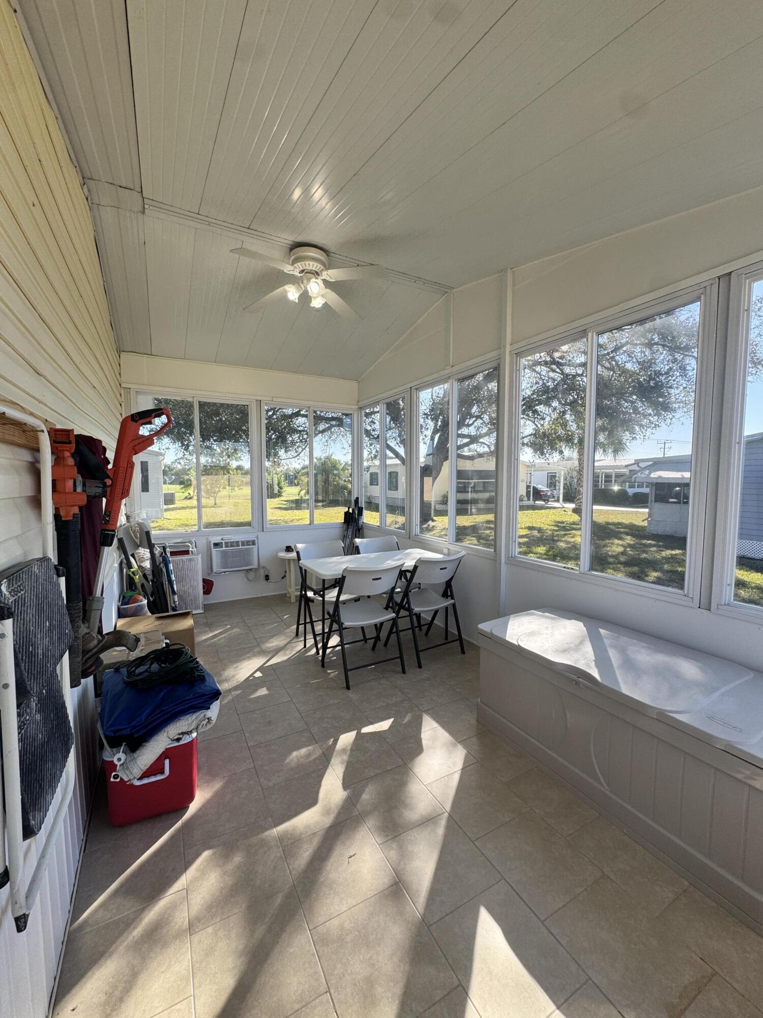 13965 Garza Court Fort Pierce, FL 34951 - Photo 43 of 44 a living room filled with furniture gym equipment and a large window