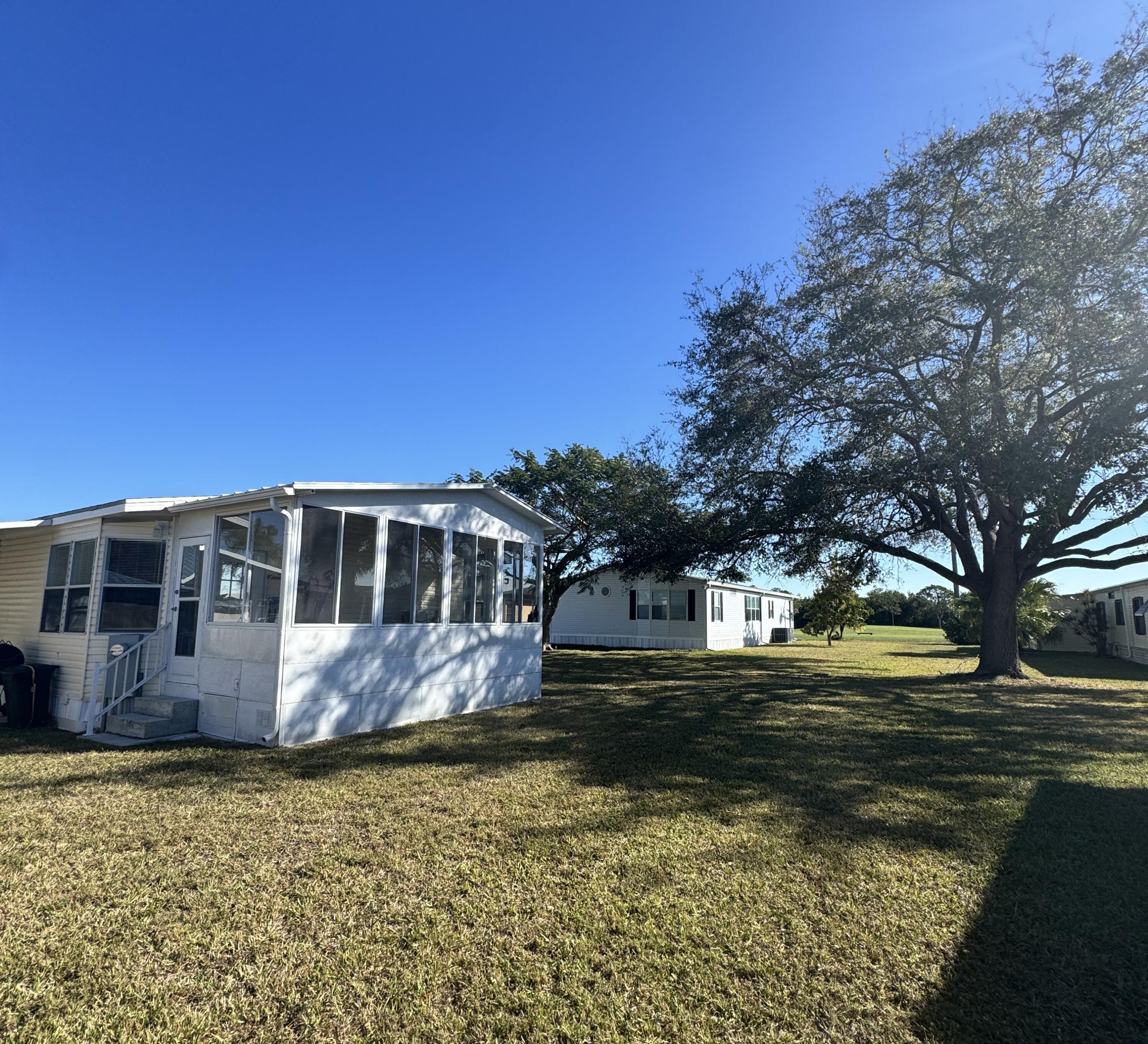 13965 Garza Court Fort Pierce, FL 34951 - Photo 8 of 44 a front view of a house with a yard