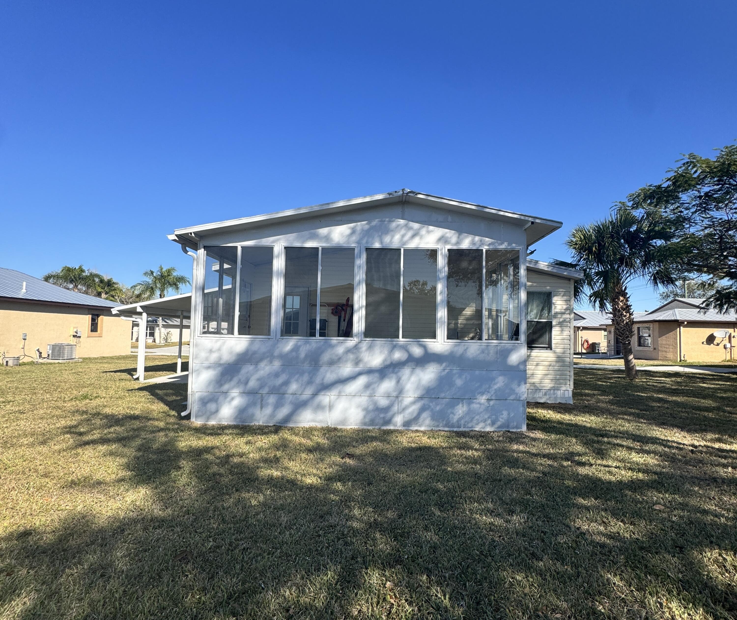 13965 Garza Court Fort Pierce, FL 34951 - Photo 9 of 44 a front view of a house with a yard
