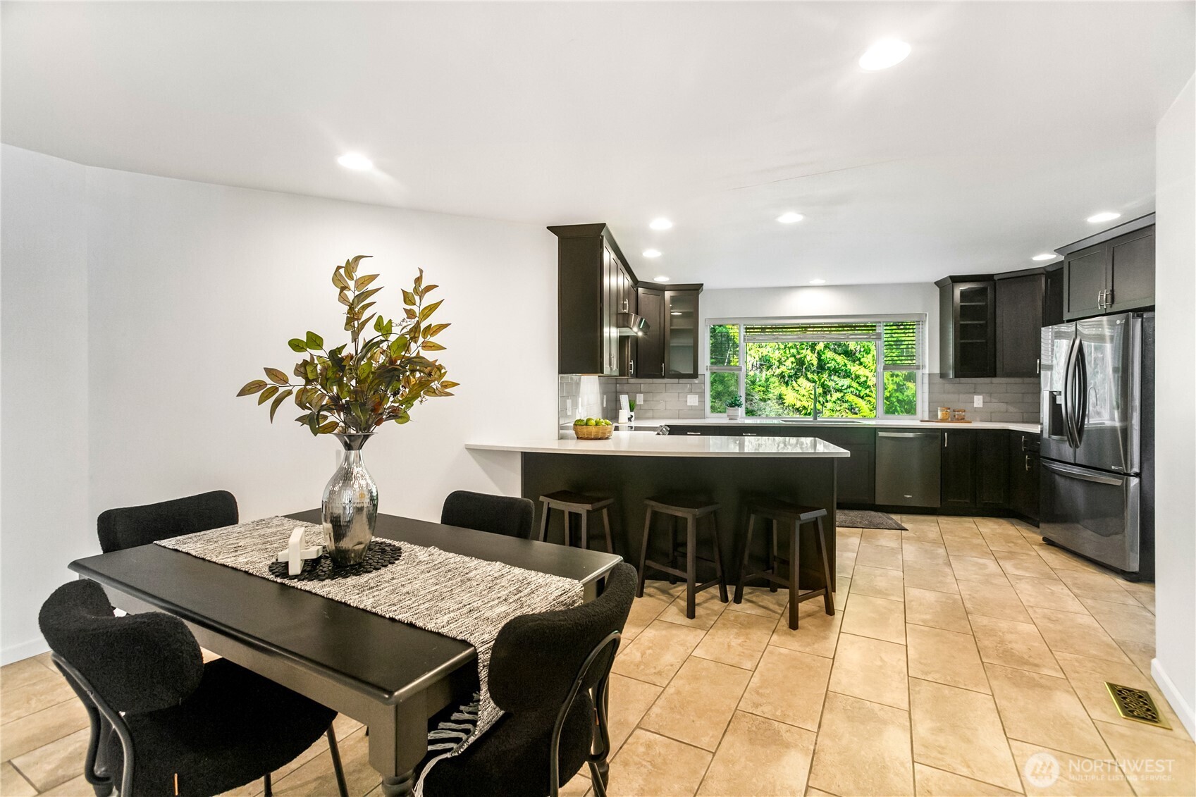 9504 Southwest Caulfield Lane Port Orchard, WA 98367 - Photo 11 of 40 a kitchen with a table and chairs in it