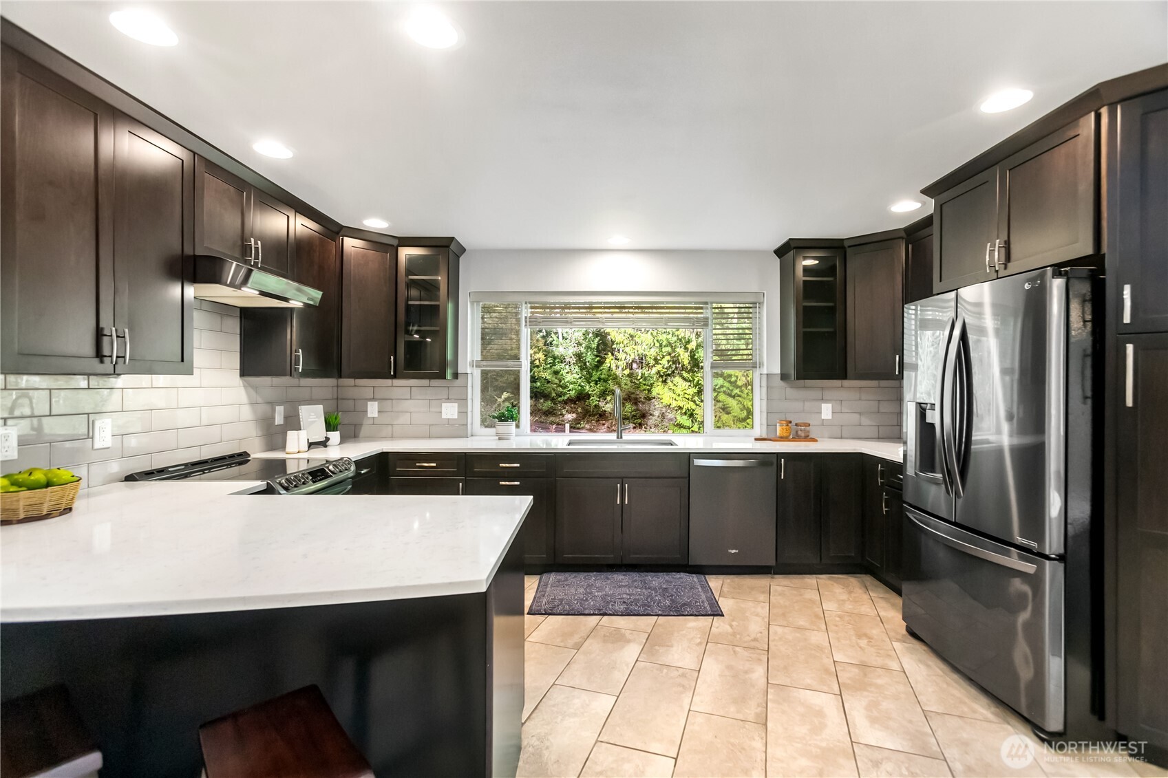 9504 Southwest Caulfield Lane Port Orchard, WA 98367 - Photo 12 of 40 a kitchen with a sink a refrigerator and chairs