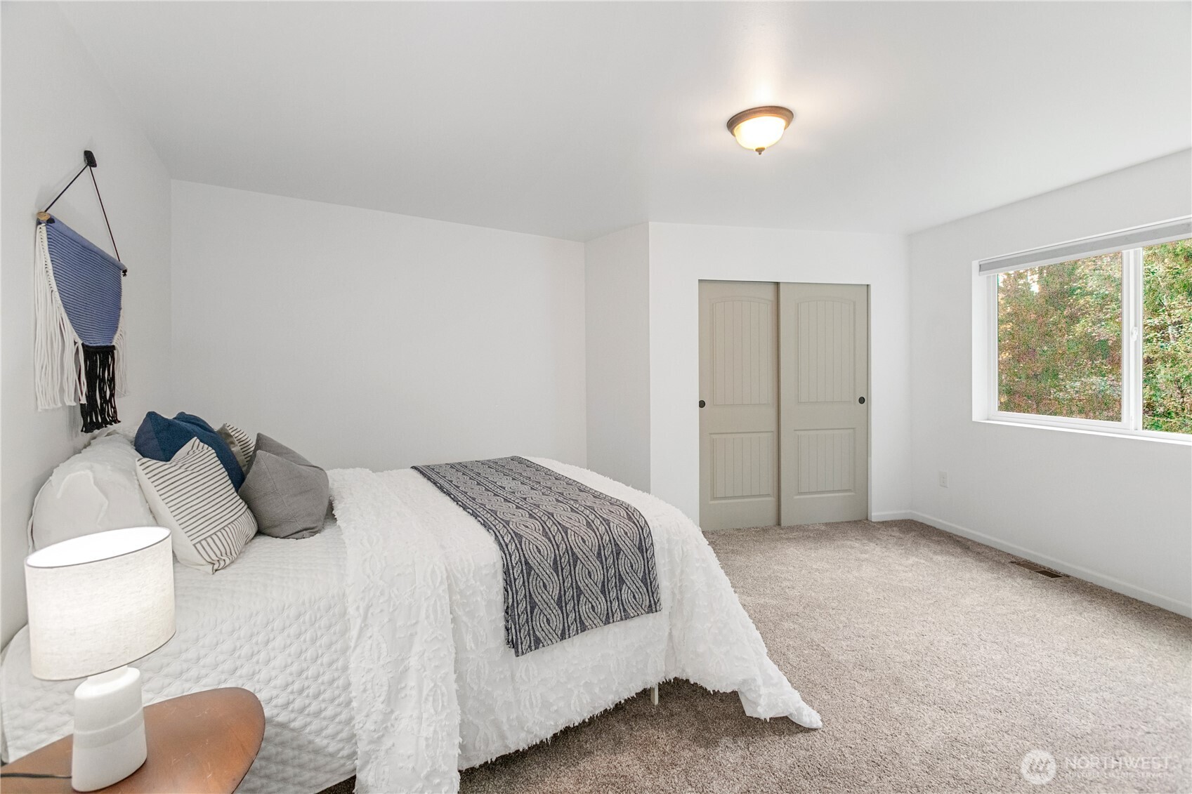 9504 Southwest Caulfield Lane Port Orchard, WA 98367 - Photo 14 of 40 a bedroom with a bed and a flat screen tv