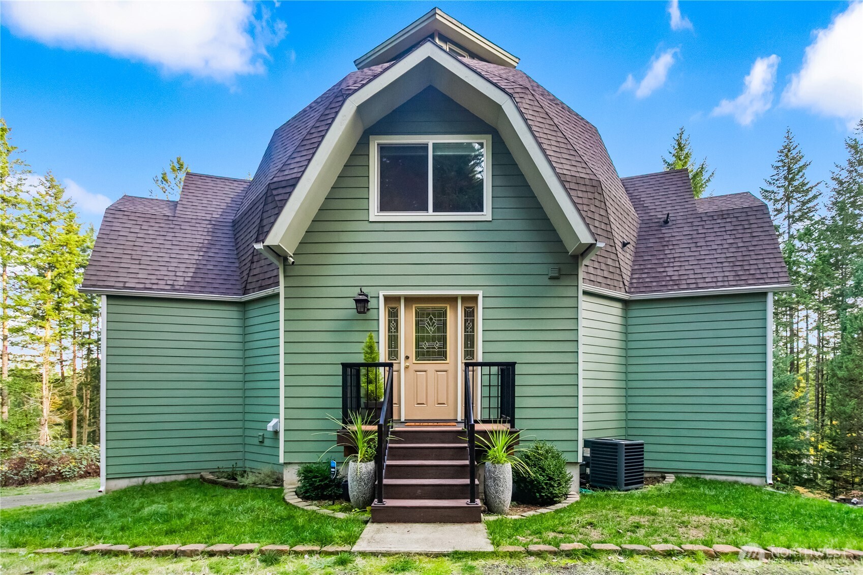 9504 Southwest Caulfield Lane Port Orchard, WA 98367 - Photo 2 of 40 a front view of a house with a garden