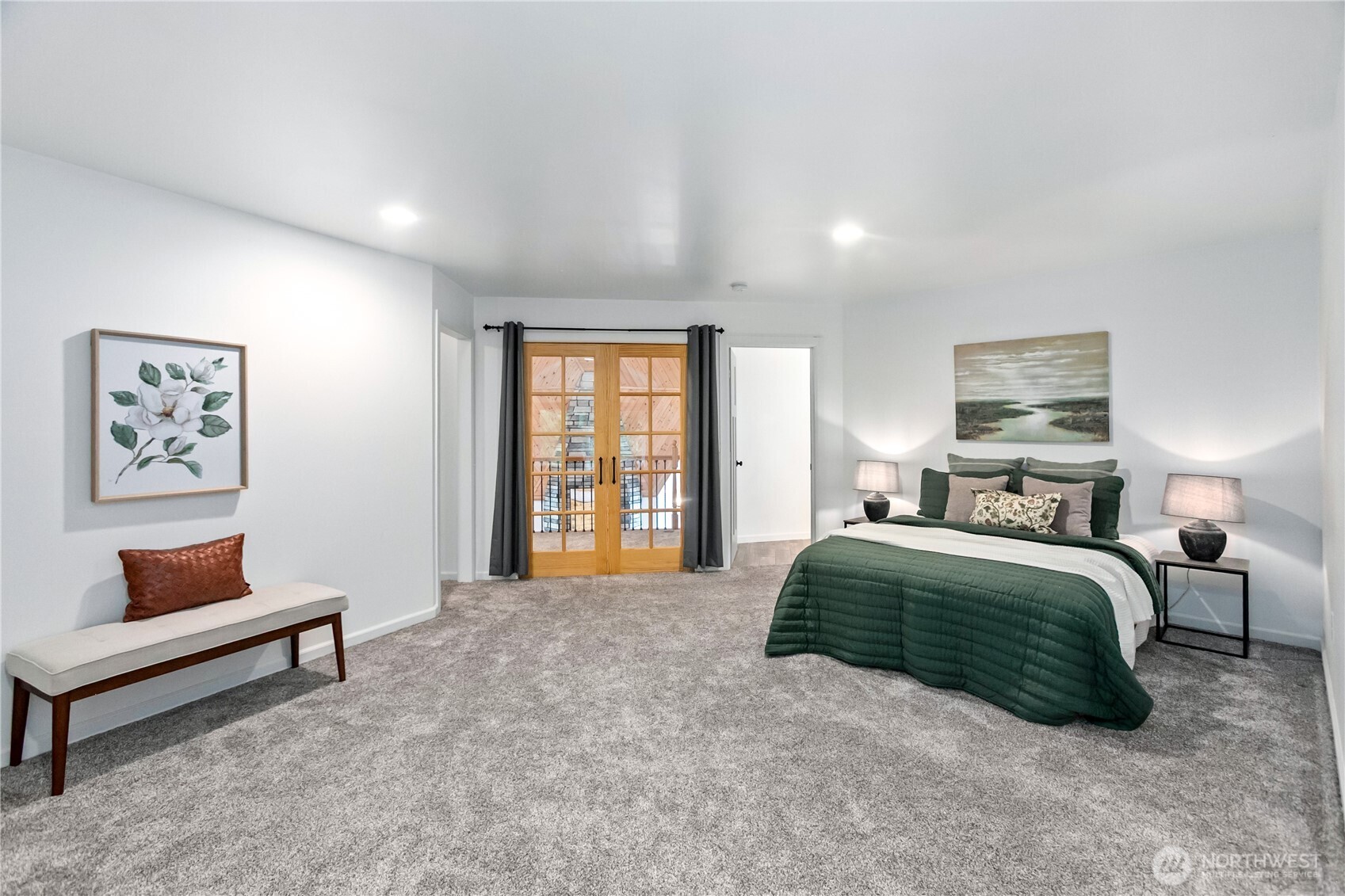 9504 Southwest Caulfield Lane Port Orchard, WA 98367 - Photo 23 of 40 a spacious bedroom with a bed a couch and a window