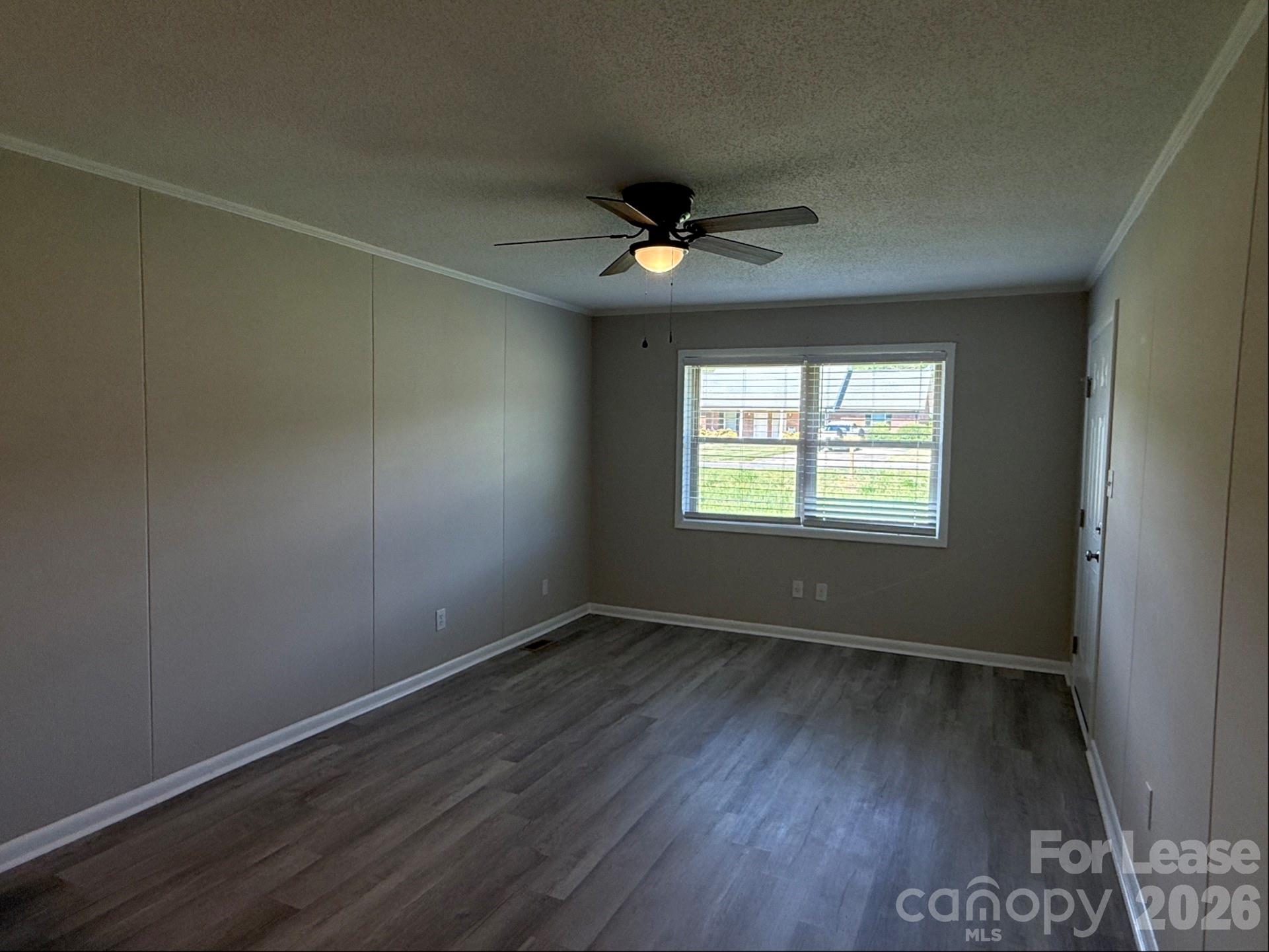 1771 River Road Lincolnton, NC 28092 - Photo 5 of 12 an empty room with wooden floor ceiling fan and windows