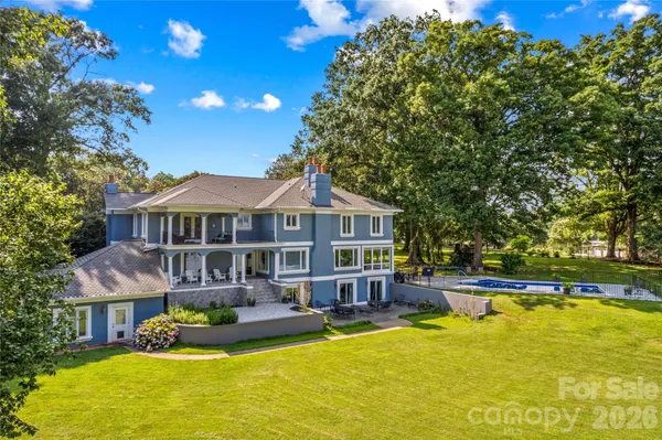 a front view of a house with swimming pool and porch