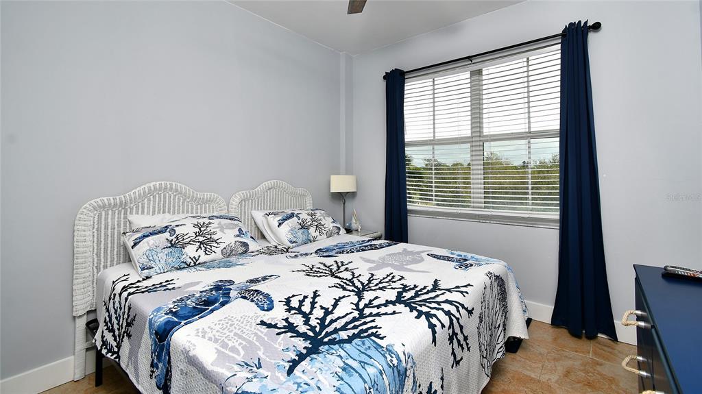 2090 Matecumbe Key Road, Unit 1308 Punta Gorda, FL 33955 - Photo 11 of 29 a bed sitting in a bedroom next to a window