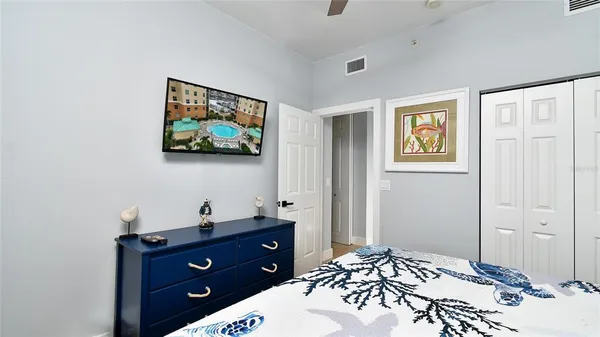 a bedroom with a bed and a flat screen tv